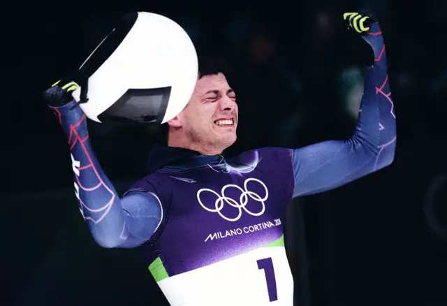 Matt Weston celebrates winning gold for Team GB in the men's skeleton at Cortina Sliding Centre