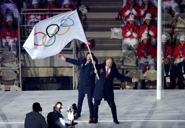 Renaud Muselier, President of the Provence-Alpes-Cote d’Azur Region, and Fabrice Pannekoucke, President of the Auvergne-Rhone-Alpes Region wave the Olympic flag