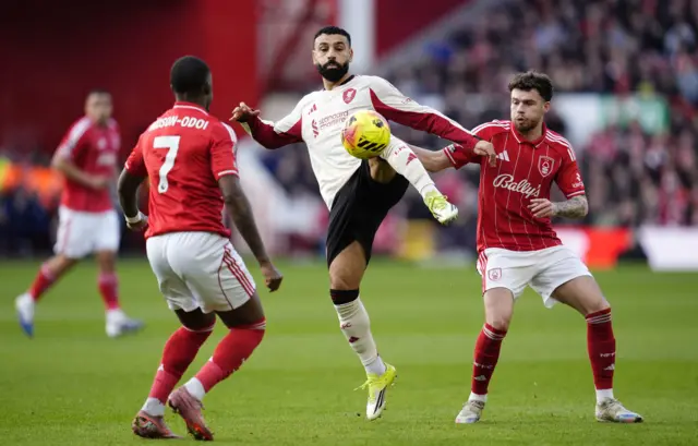 Liverpool's Mohamed Salah (centre) and Nottingham Forest's Neco Williams (right) battle for the bal