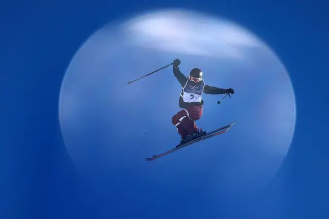 Megan Oldham pictured against a flat blue sky