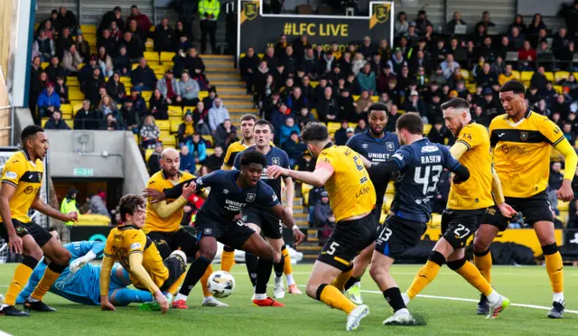 Rangers players battle in the Livingston box