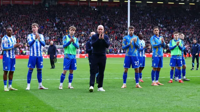 Henrik Pedersen is stood in the middle with Sheffield Wednesday players behind him, clapping the club's supporters at Bramall Lane