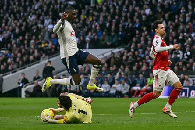 Randal Kolo Muani (top L) jumps over Arsenal's Spanish goalkeeper  David Raya