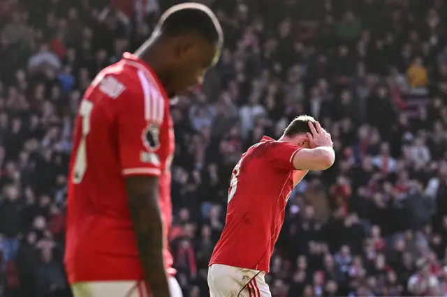 Nottingham Forest's English midfielder #08 Elliot Anderson (R) reacts after a missed shot