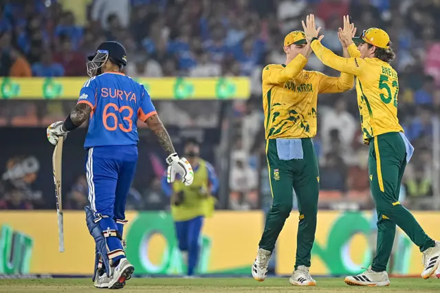South Africa's Dewald Brevis (R) celebrates with teammate Tristan Stubbs (C) after taking a catch to dismiss India's captain Suryakumar Yadav