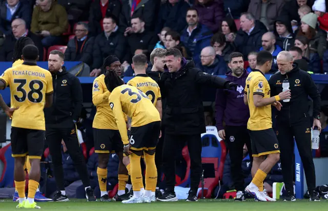 Rob Edwards, Manager of Wolverhampton Wanderers, interacts