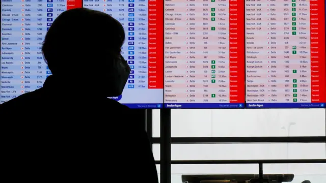 Cancelled flights are displayed on a board at Logan International Airport during a winter blizzard snow storm in Boston, Massachusetts, US, 23 February 2026.