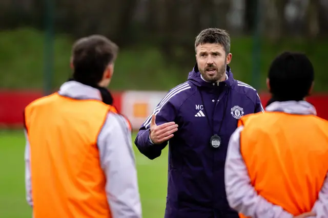 Carrick chats to players during training