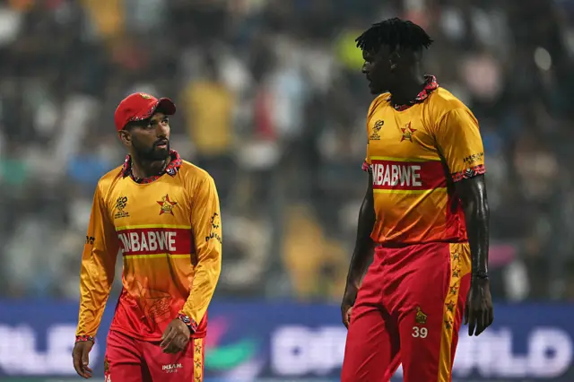 Zimbabwe's captain Sikandar Raza (L) and Richard Ngarava speak