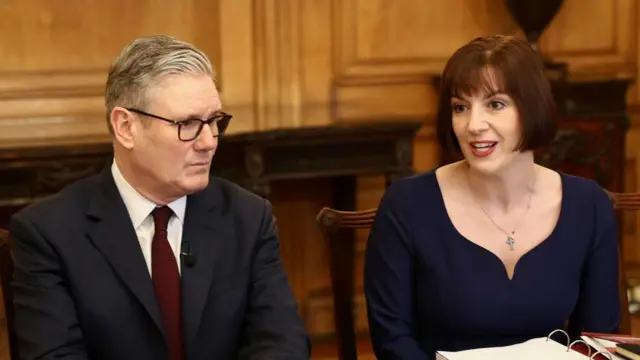 Prime Minister Sir Keir Starmer and Education Secretary Bridget Phillipson sit next to each other around a table