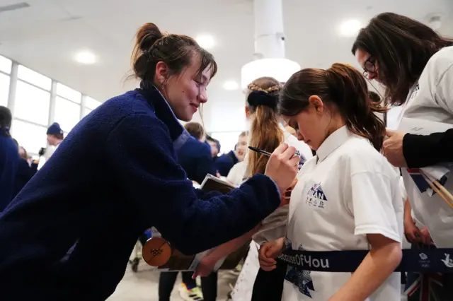 Zoe Atkin signs autographs