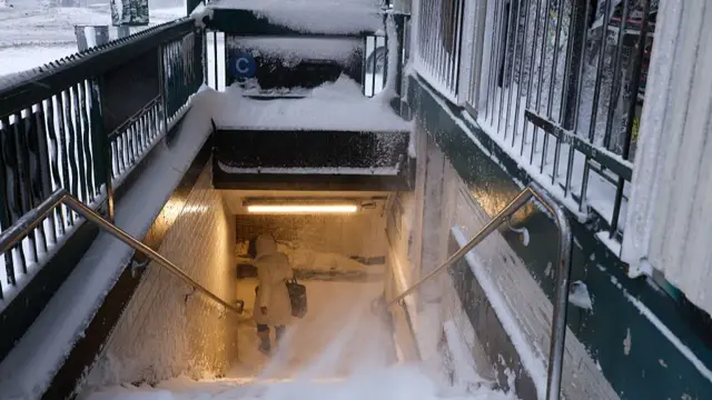 A woman enters a subway train station in the Hamilton Heights neighborhood in the Manhattan borough of New York City on 23 February 2026.