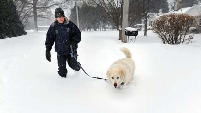 Patricia Berg walks her Great Pyrenees dog, Gracie, through blowing snow in Fairfield on Monday morning February 23, 2026.