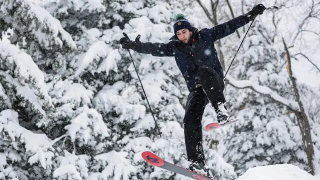 A man skis in the snow in Central Park as snow falls during a winter storm in New York City, U.S., February 23, 2026.