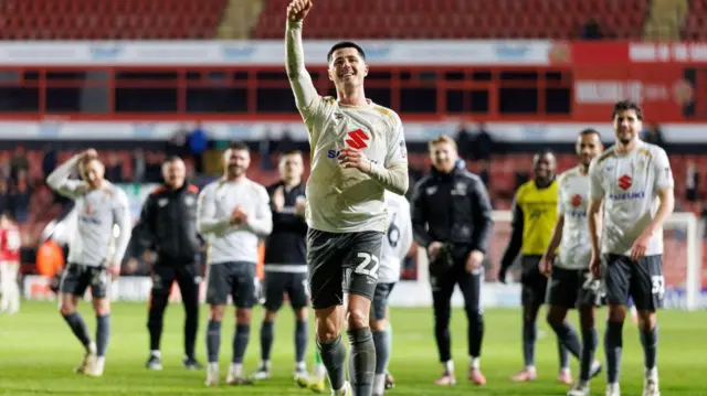 MK Dons players celebrate at the Bescot Stadium