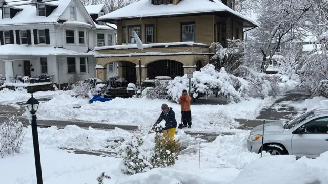 Neighbours digging out snow