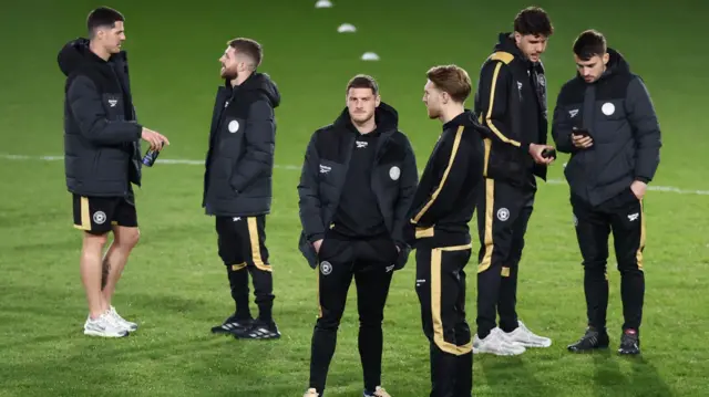 MK Dons players on the pitch at Bescot Stadium before their game against Walsall