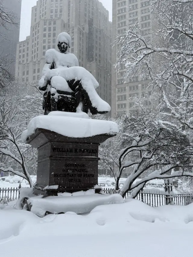 A snow covered statue at