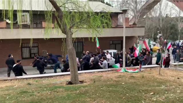 Students are chased by members of the paramilitary pro-government volunteer Basij force at Iran's University of Science and Technology in Tehran