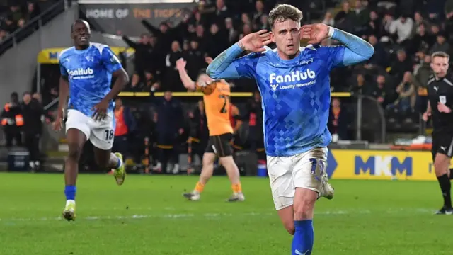 Sam Szmodics cups his ears in celebration