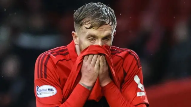 Aberdeen's Liam Morrison looks dejected after being sent off during a William Hill Premiership match between Aberdeen and Dundee at Pittodrie Stadium