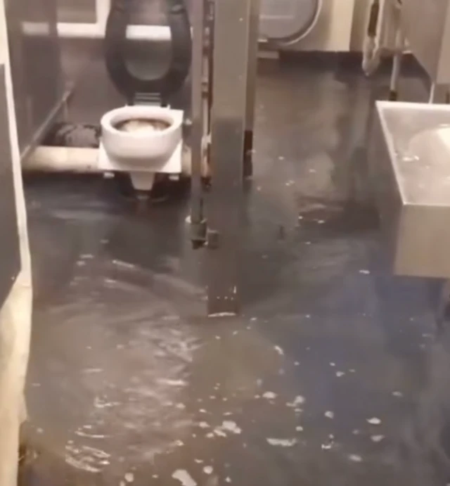 A screengrab from a 2023 video shows sewage overflowing in a bathroom