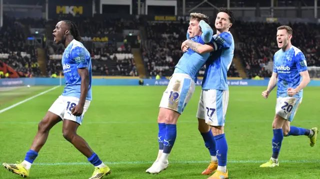 Derby players celebrate with Sam Szmodics