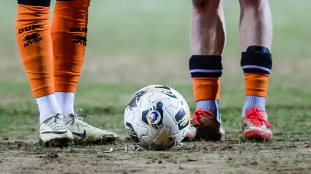 Footballers with a football