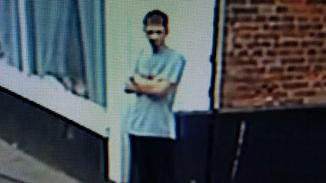 Still from CCTV still showing Skebas standing on a street corner wearing a t-Shirt and dark trousers