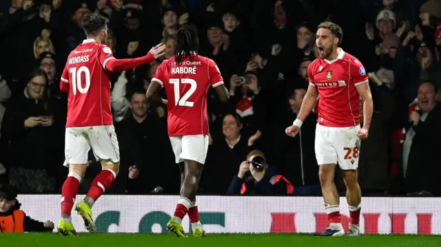 Wrexham players celebrate with Sam Smith