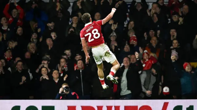 Sam Smith leaps into the air to celebrate his goal against Portsmouth