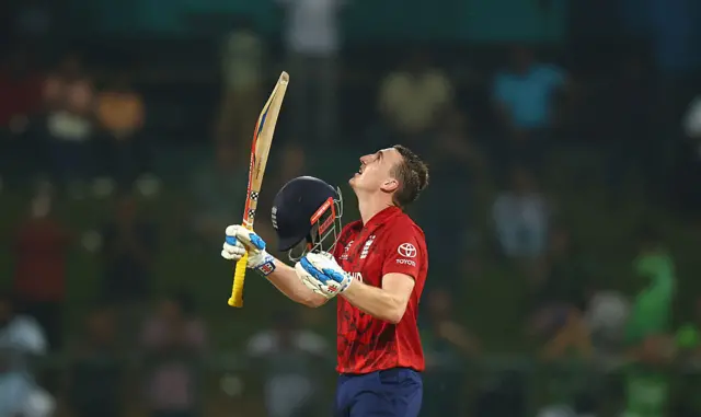 Harry Brook points his bat to the heavens