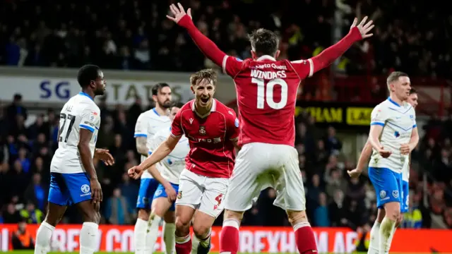 Wrexham's Max Cleworth celebrates with Josh Windass