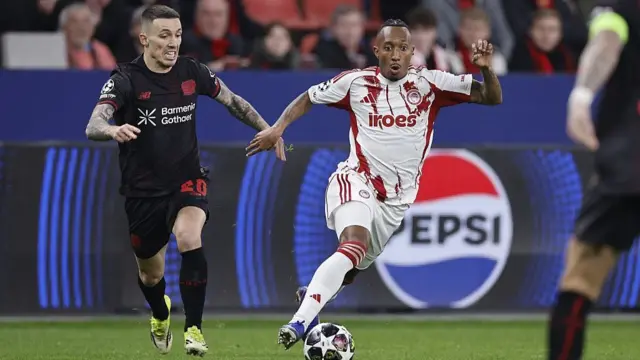 Alejandro Grimaldo of Bayer 04 Leverkusen, Gelson Martins of Olympiakos during the UEFA Champions League match between Bayer 04 Leverkusen v Olympiakos Piraeus at the BayArena on February 24, 2026