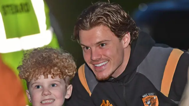 Hull's Regan Slater poses with a young fan before their game against Derby