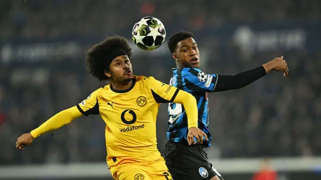 Honest Ahanor and Karim Adeyemi challenge for the ball