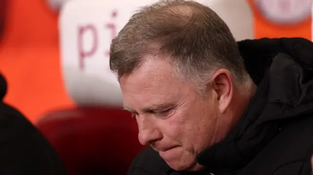A dejected looking Stoke City boss Mark Robins