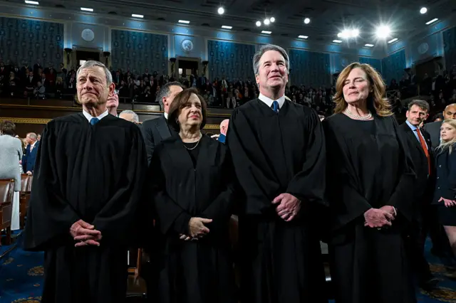 Four judges in black robes