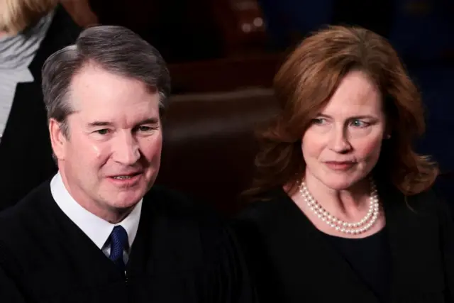 A man and an woman in black robes
