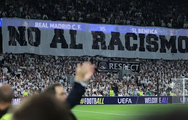 A banner against racism is pictured