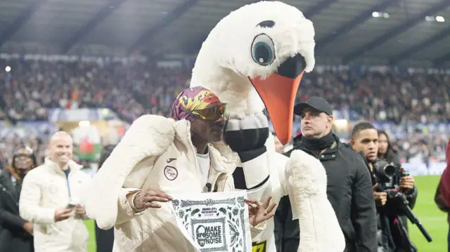 Swansea City club co-owner Snoop Dogg with club mascot Cyril the Swan,