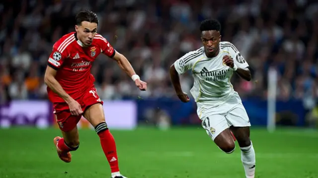 Vinicius Jr and Amar Dedic chase the ball