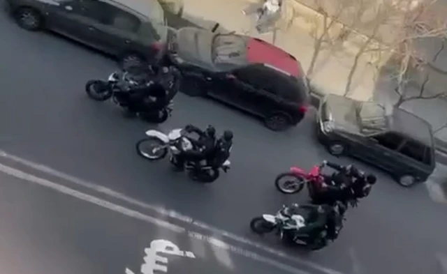 Eight security forces members riding on four motorbikes