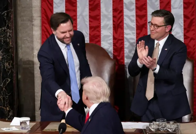 Trump turns to shake Vice President JD Vance's hand while Speaker Johnson applauds