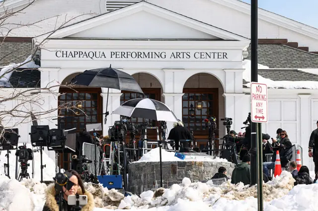 Members of the media gather outside the Chappaqua Performing Arts Center as members of the House Oversight Committee conduct a deposition with former Secretary of State Hillary Clinton