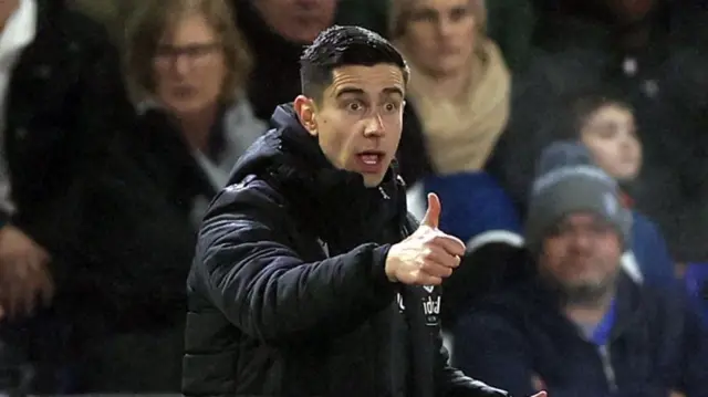 Eric Ramsay looks shocked and gives a thumbs up