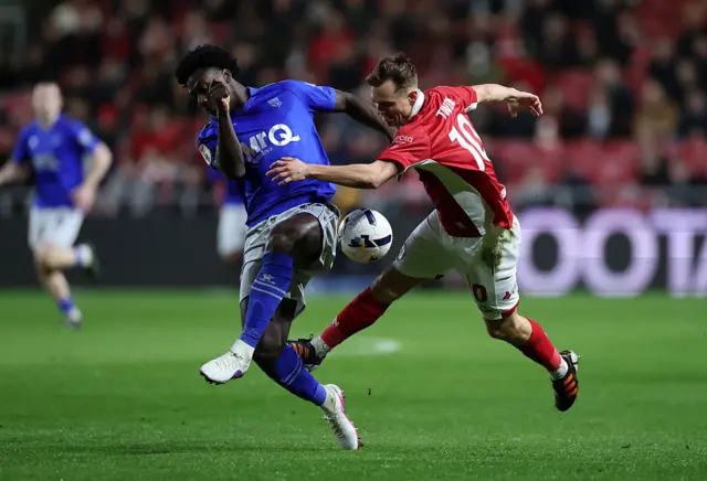 Scott Twine of Bristol City battles for the ball with James Abankwah of Watford