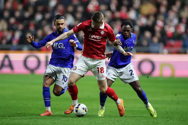 Emil Riis Jakobsen of Bristol City (c) holds off Imran Louza and Jeremy Ngakia of Watford