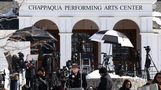 Dozens of cameras set up outside the Chappaqua Performing Arts Center with journalists walking around