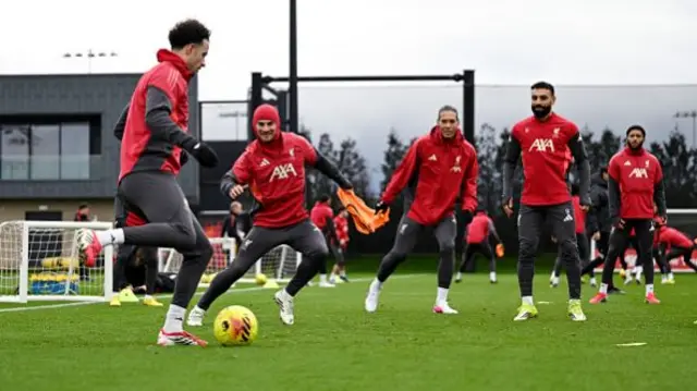 Alexis Mac Allister and Mohamed Salah of Liverpool looks on
